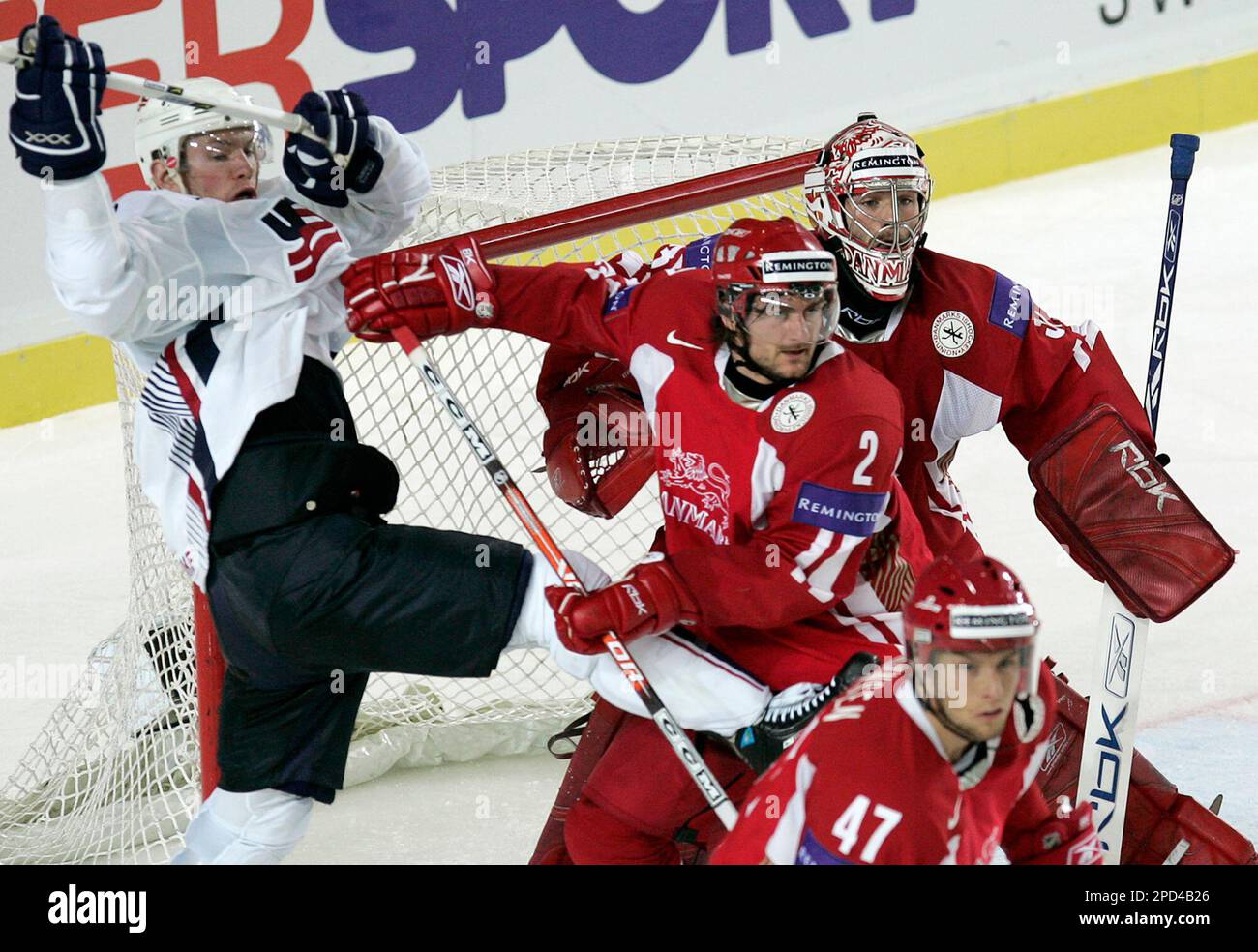 Adam Hall,of the United States, left, struggles with Denmarks defender Rasmus Pander, center, as Denmarks Thomas Johnsen, right, and Peter Hirsch, second right, watch the puck, unseen, during their IIHF Ice Hockey