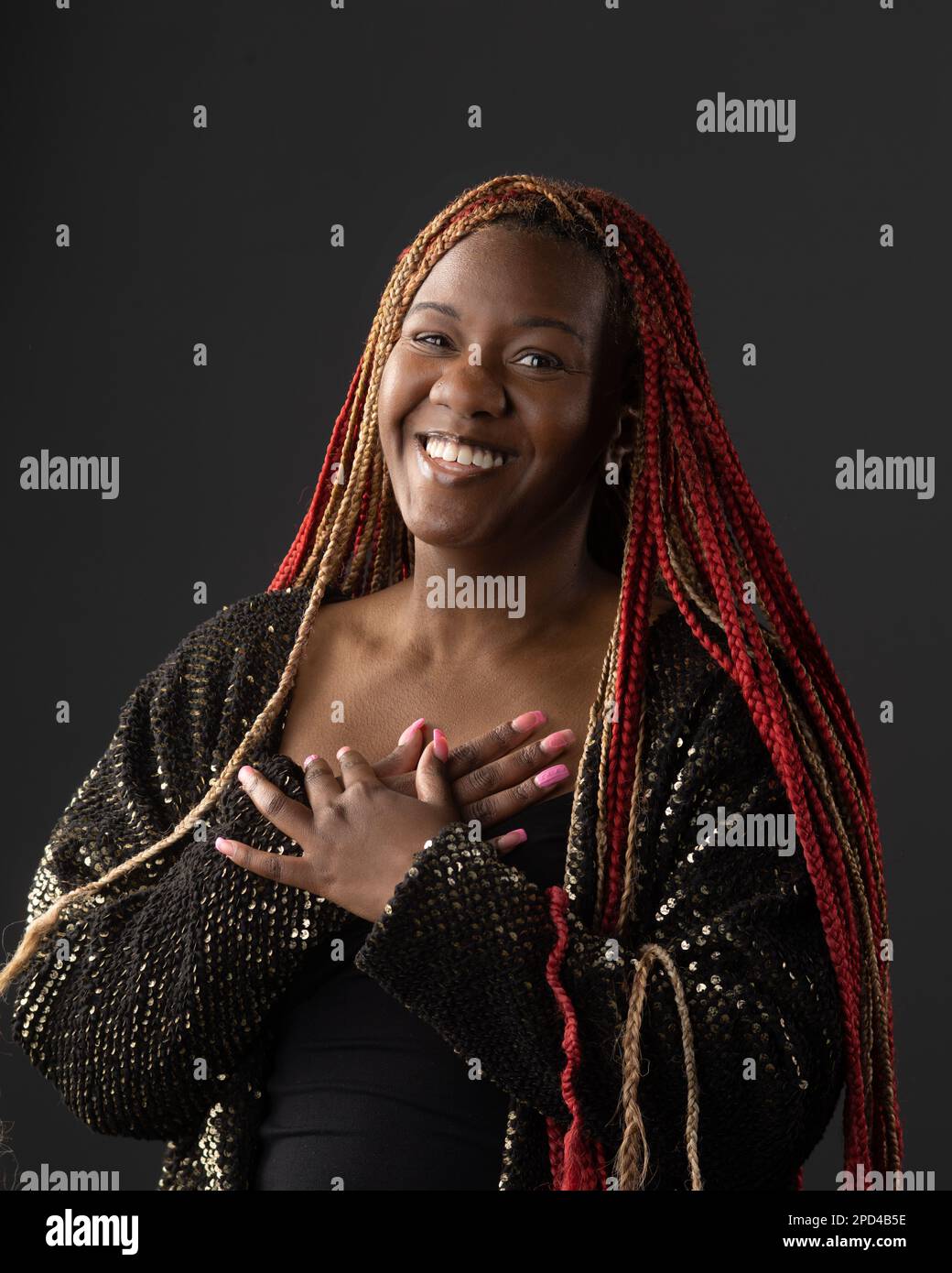 A portrait of a happy African American female with red braids against a ...