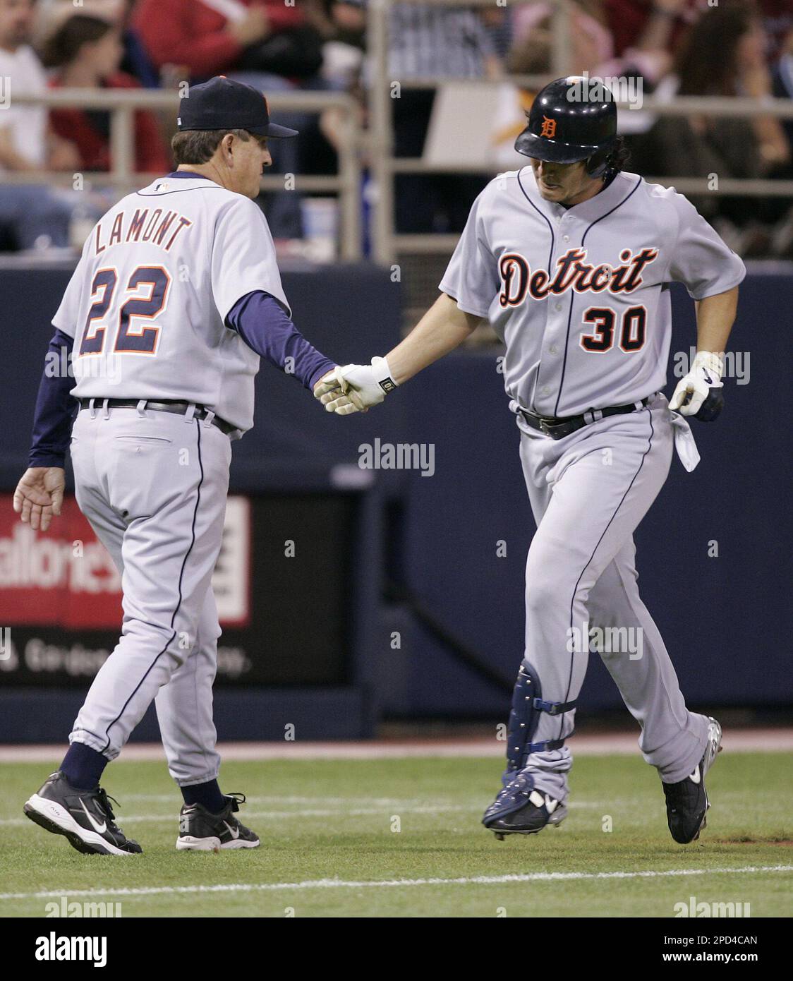 Detroit Tigers third base coach Gene Lamont, left, congratulates ...