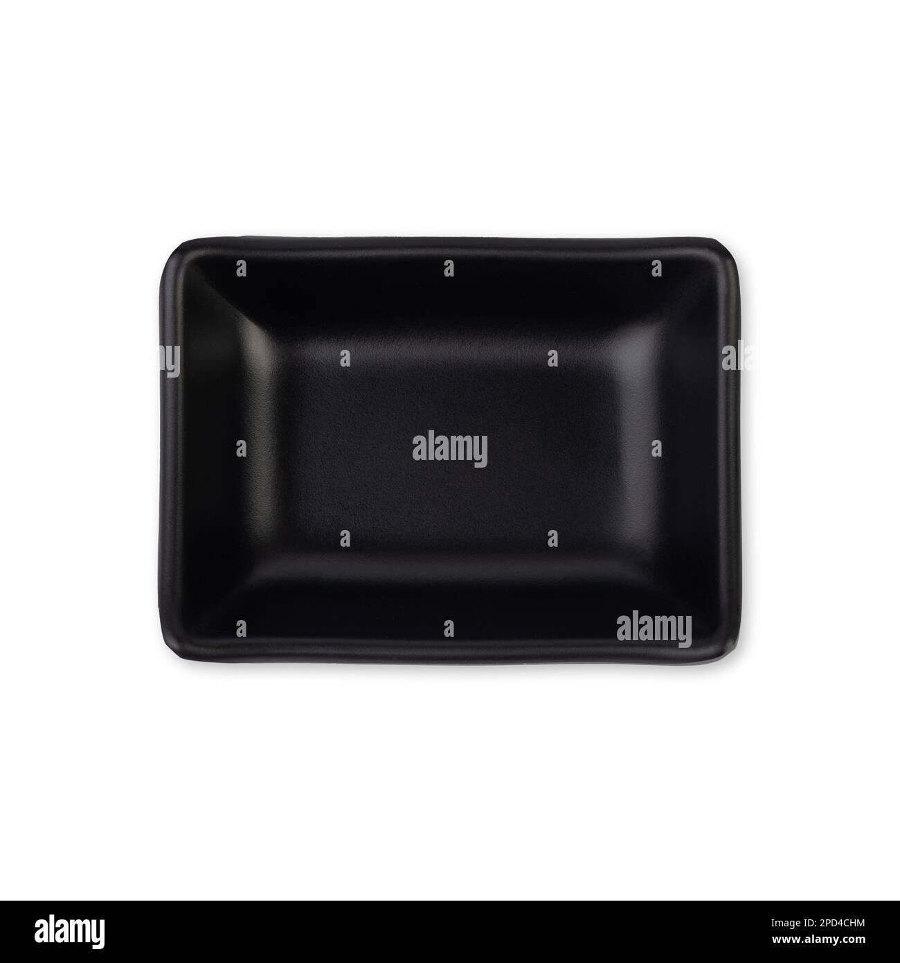 Small black ceramic plate isolated over white background. Stock Photo