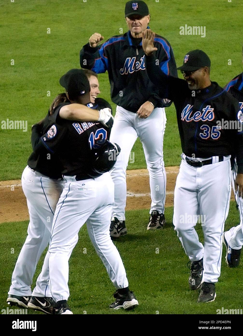 New York Mets' David Wright, lower left, receives a hug from manager Willie Randolph as coaches