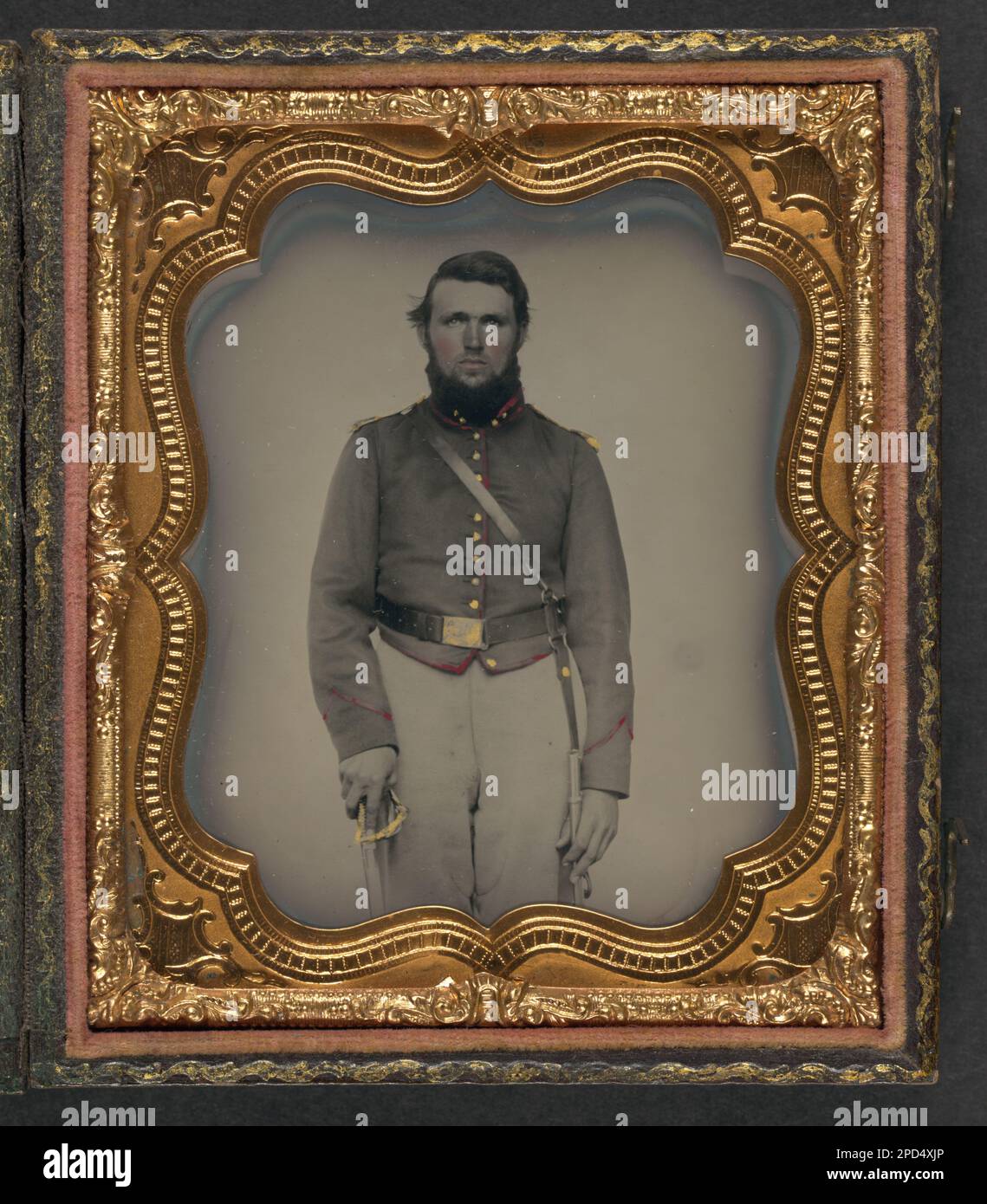 Unidentified soldier in Union artillery uniform with red piping holding