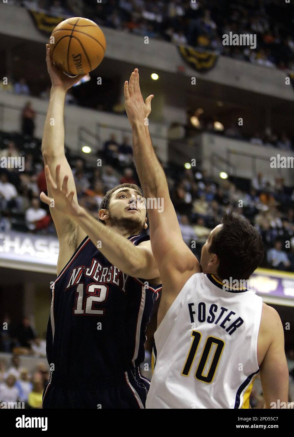 New Jersey Nets forward Nenad Krstic (12) drives to the basket against  Indiana Pacers forward Austin Croshere (44) in game 6 of their first round  playoff series at Conseco Fieldhouse in Indianapolis