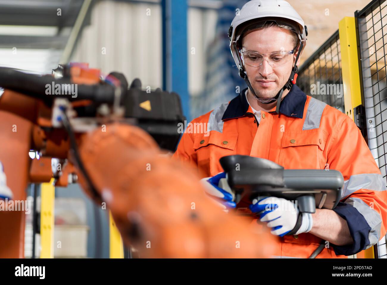 A team of male engineers meeting to inspect computer-controlled steel ...