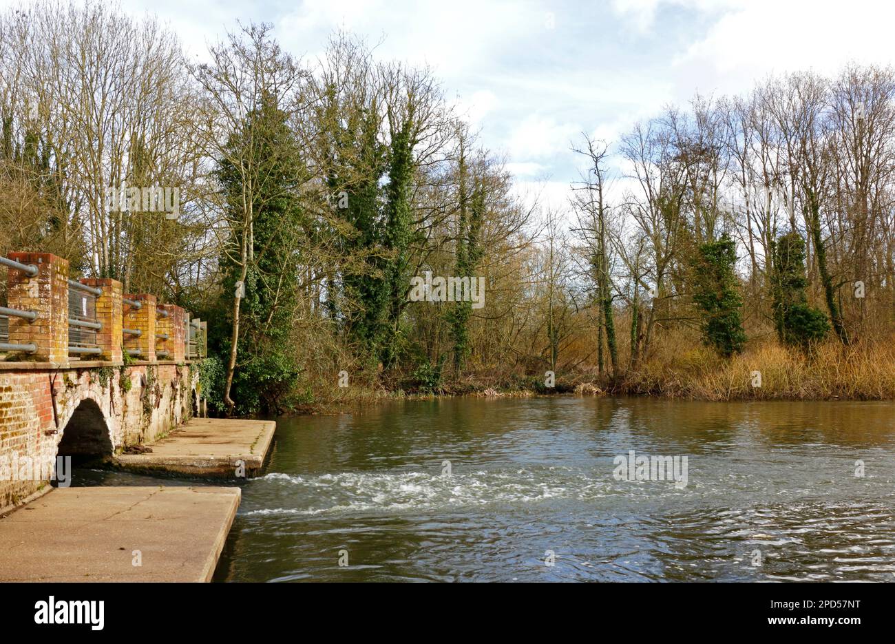 A view of the burnt down remains of the watermill and the mill pool on the River Bure at Horstead, Norfolk, England, United Kingdom. Stock Photo