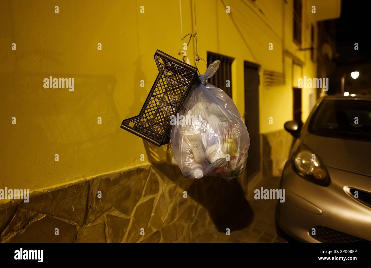 Garbage on a rope on an Italian street. Stock Photo