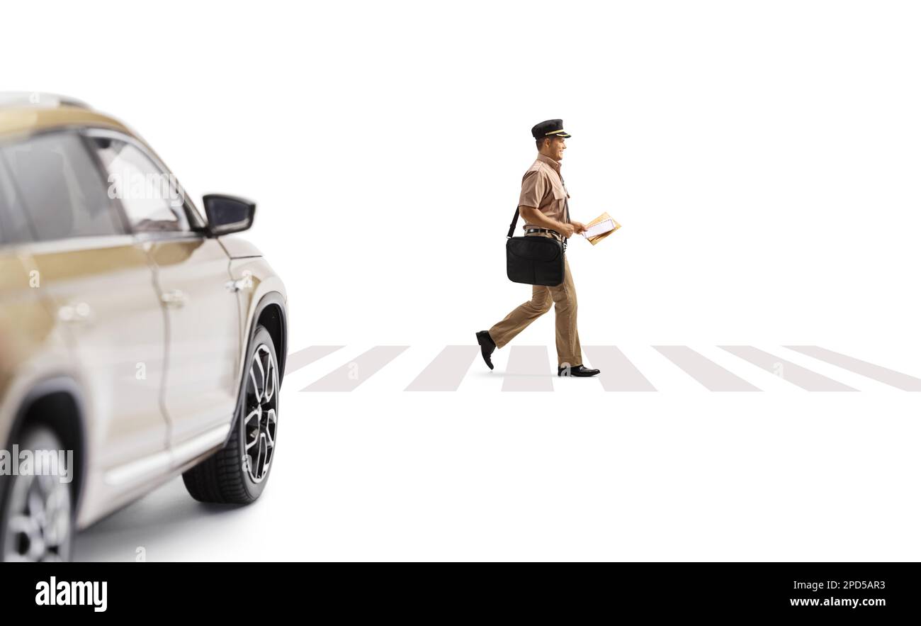 Full length profile shot of a postman walking on a pedestrian crossing and car waiting isolated on white background Stock Photo