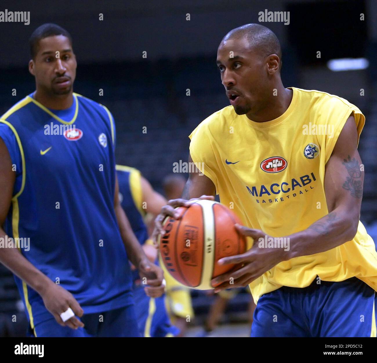 Maccabi Tel Aviv player Willie Solomon, right, duels for the ball with Jamie Arnold during their team Euroleague Basketball Final Four 2006 official practice, Thursday, April 27, 2006, in Prague, Czech Republic