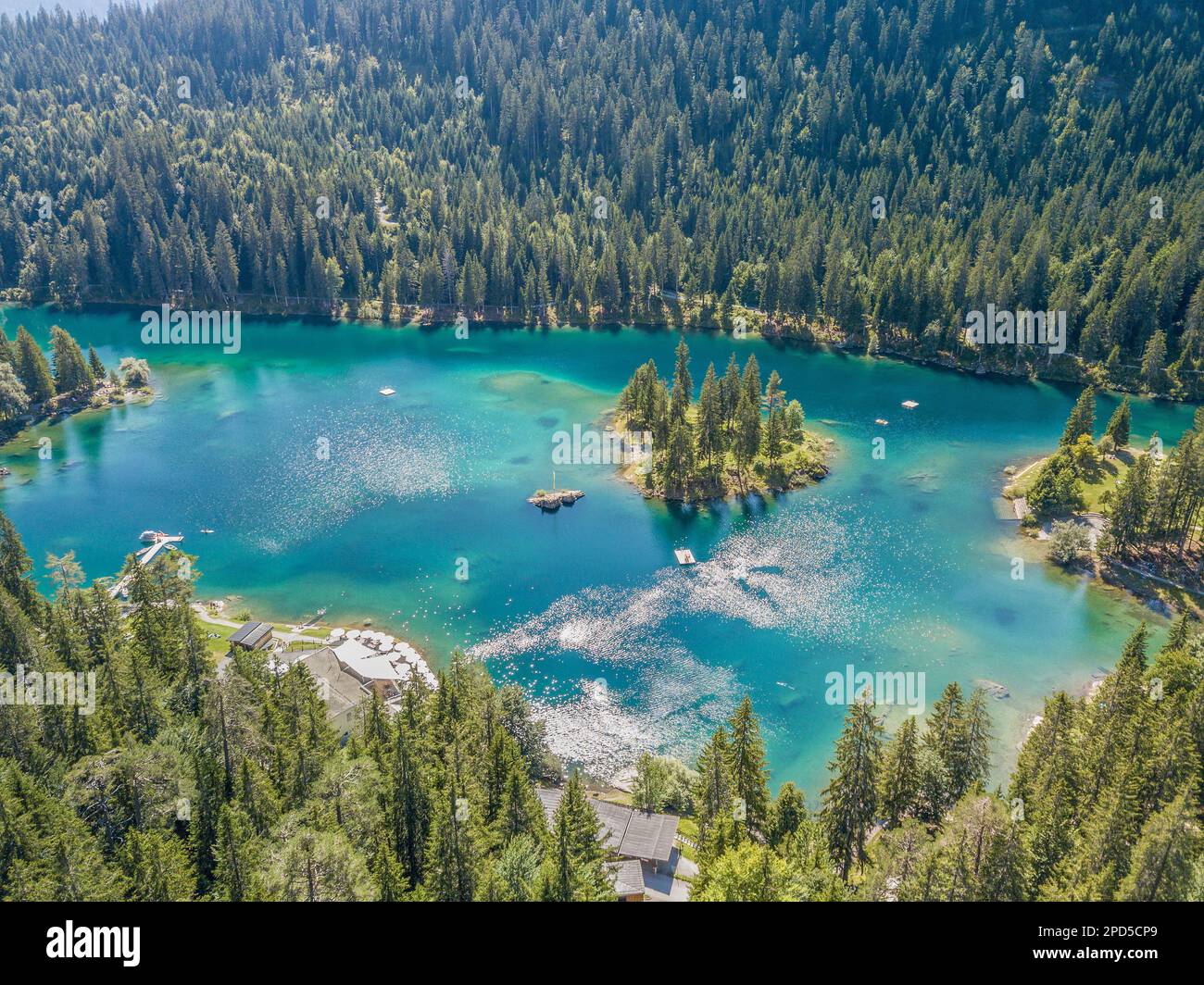 Aerial image of the turquoise Caumasee lake in the alpine mountains in ...