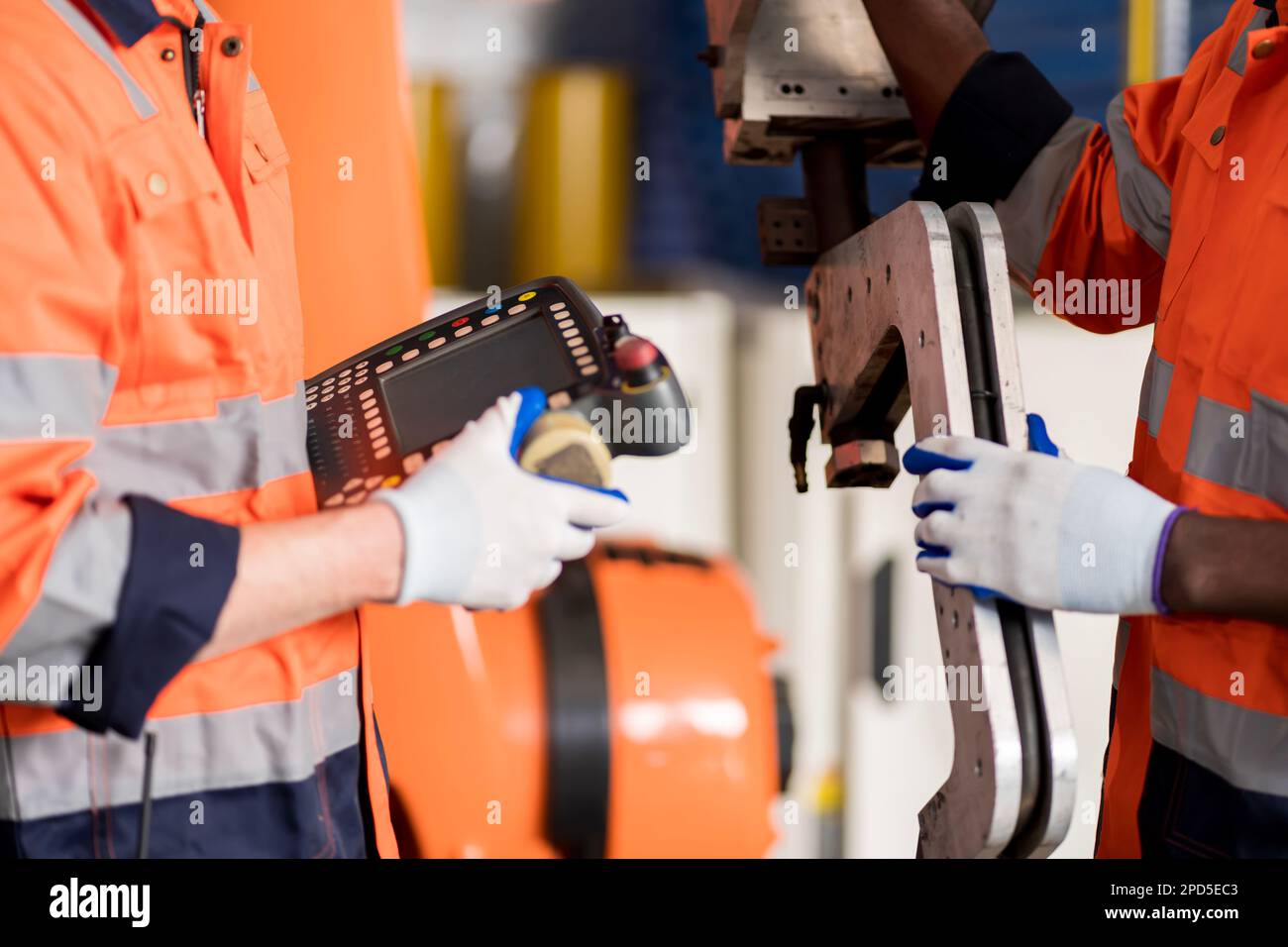A team of male engineers meeting to inspect computer-controlled steel ...