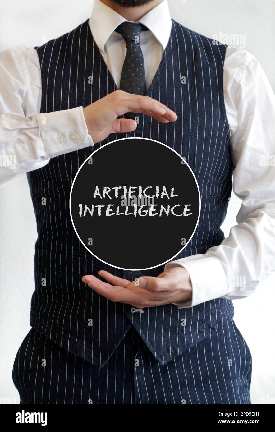 Man in suit holding a sign with Artificial Intelligence written on it Stock Photo
