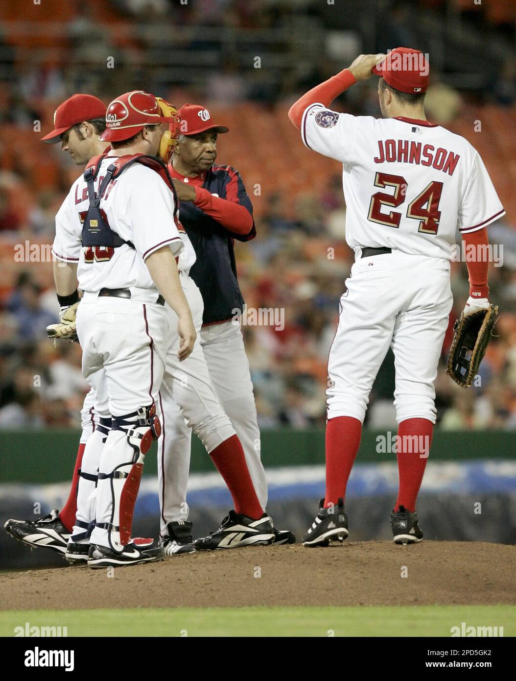 Washington Nationals manager Frank Robinson pats pitcher Bill Traber,  center left, on the back after taking him out during the top of the second  inning of their Major League Baseball game against