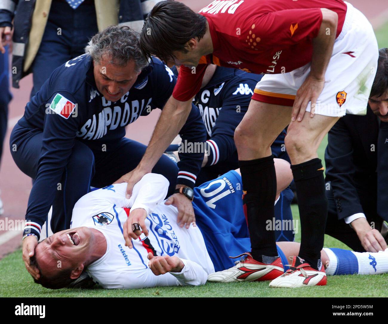 Sampdoria's striker Francesco Flachi, on the ground, is comforted