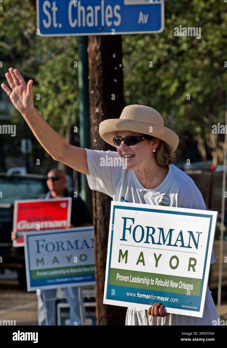 Campaign worker Anne Grace waves to motorist while campaigning for New