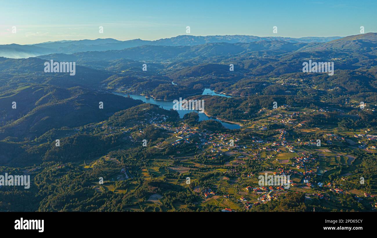 Aerial view of urban buildings in a lush green mountainous landscape ...