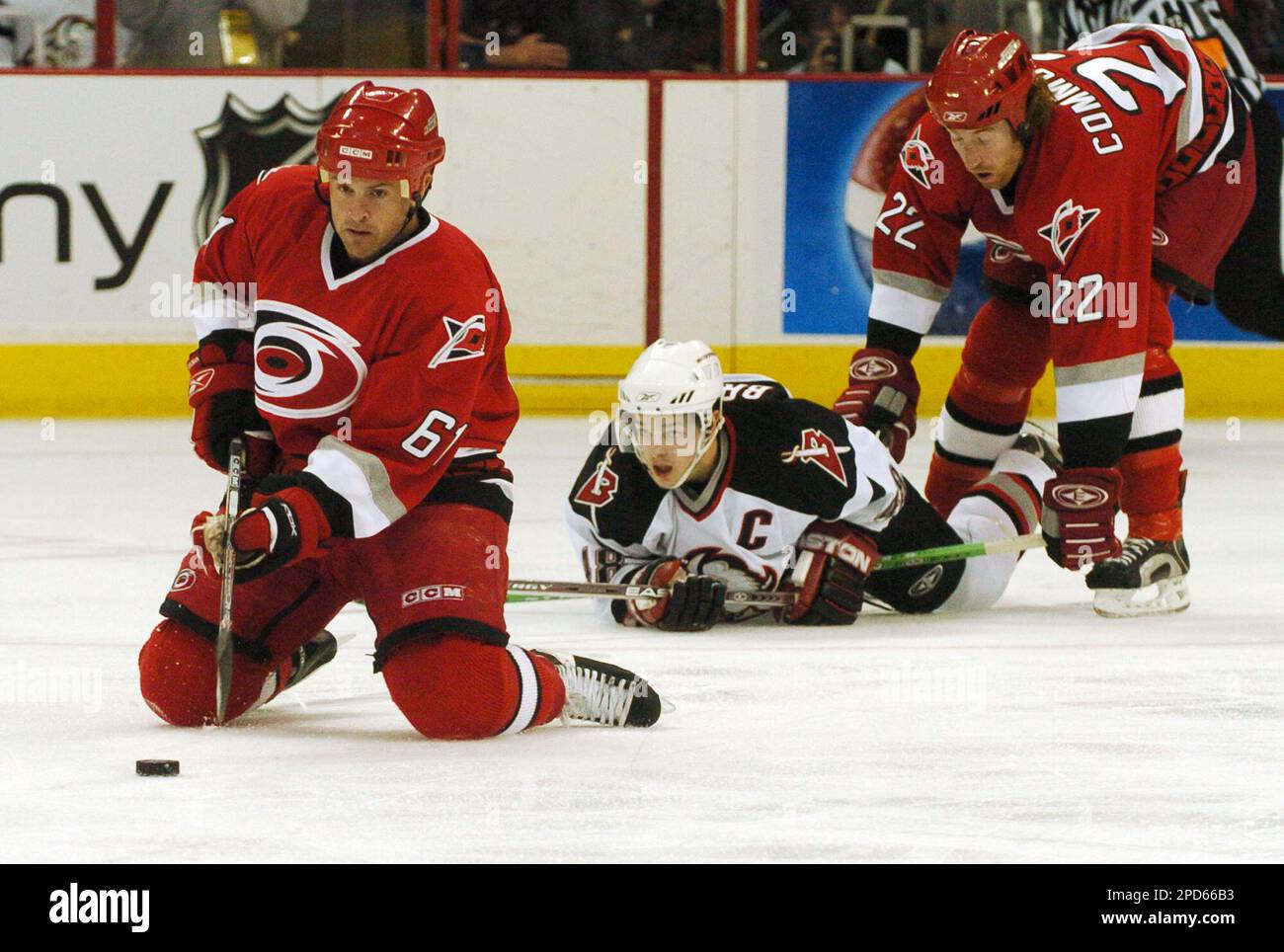 Carolina Hurricanes' Cory Stillman (61) chases the puck on his knees