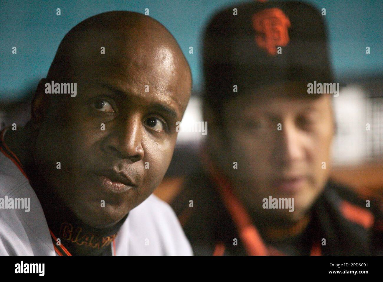 San Francisco Giants' Barry Bonds, left, sits in the dugout with actor Rob  Schneider during the Giants' Major League baseball game against the Los  Angeles Dodgers, Saturday night, April 15, 2006 in