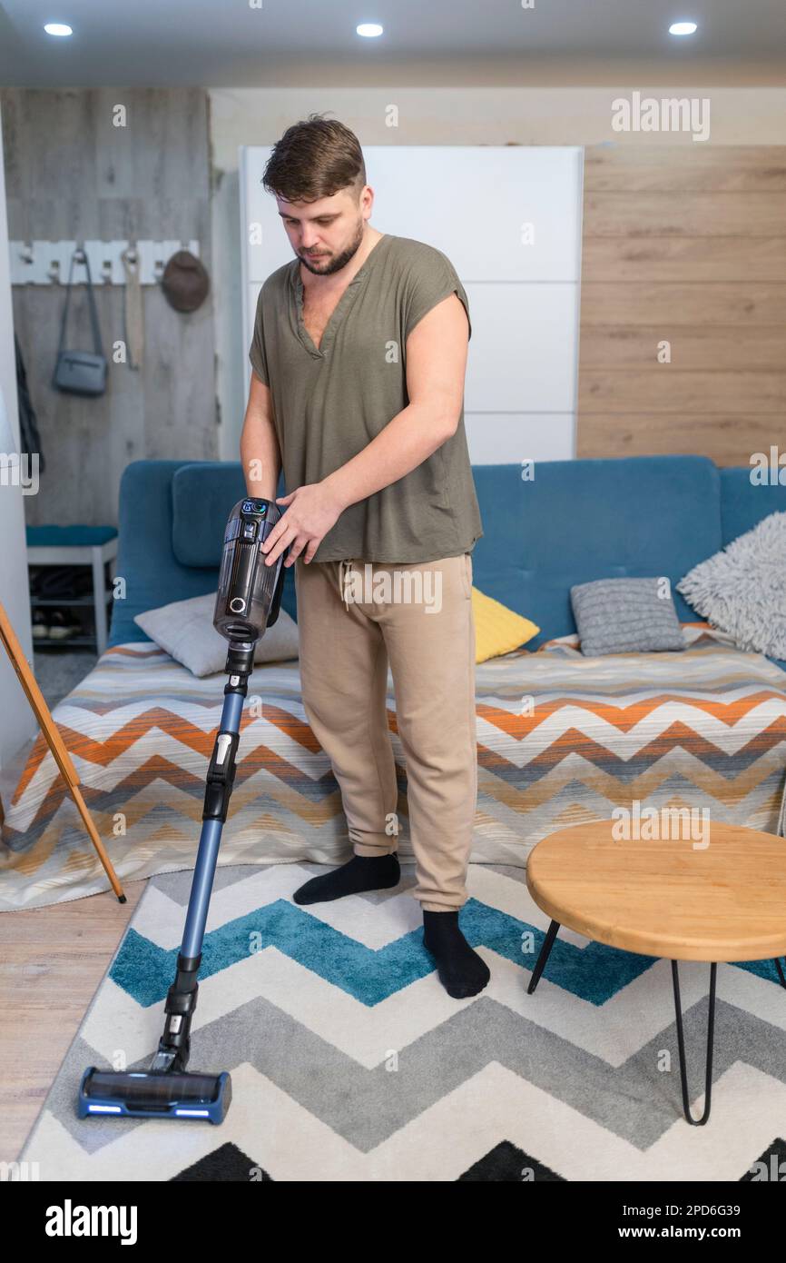 Man husband cleaning the house helping wife Stock Photo - Alamy