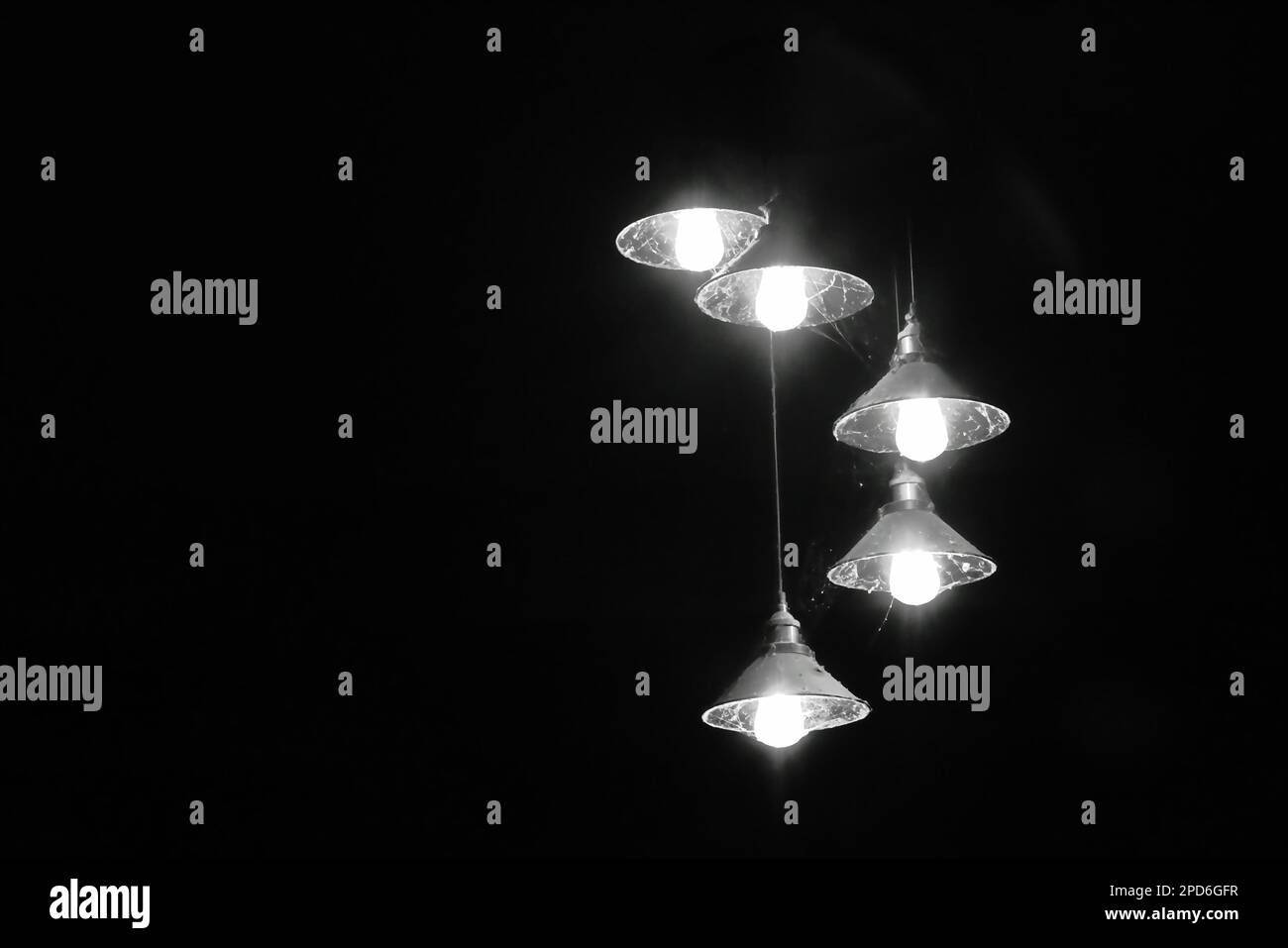 electric lamp hanging from ceiling on the night in black and white tone
