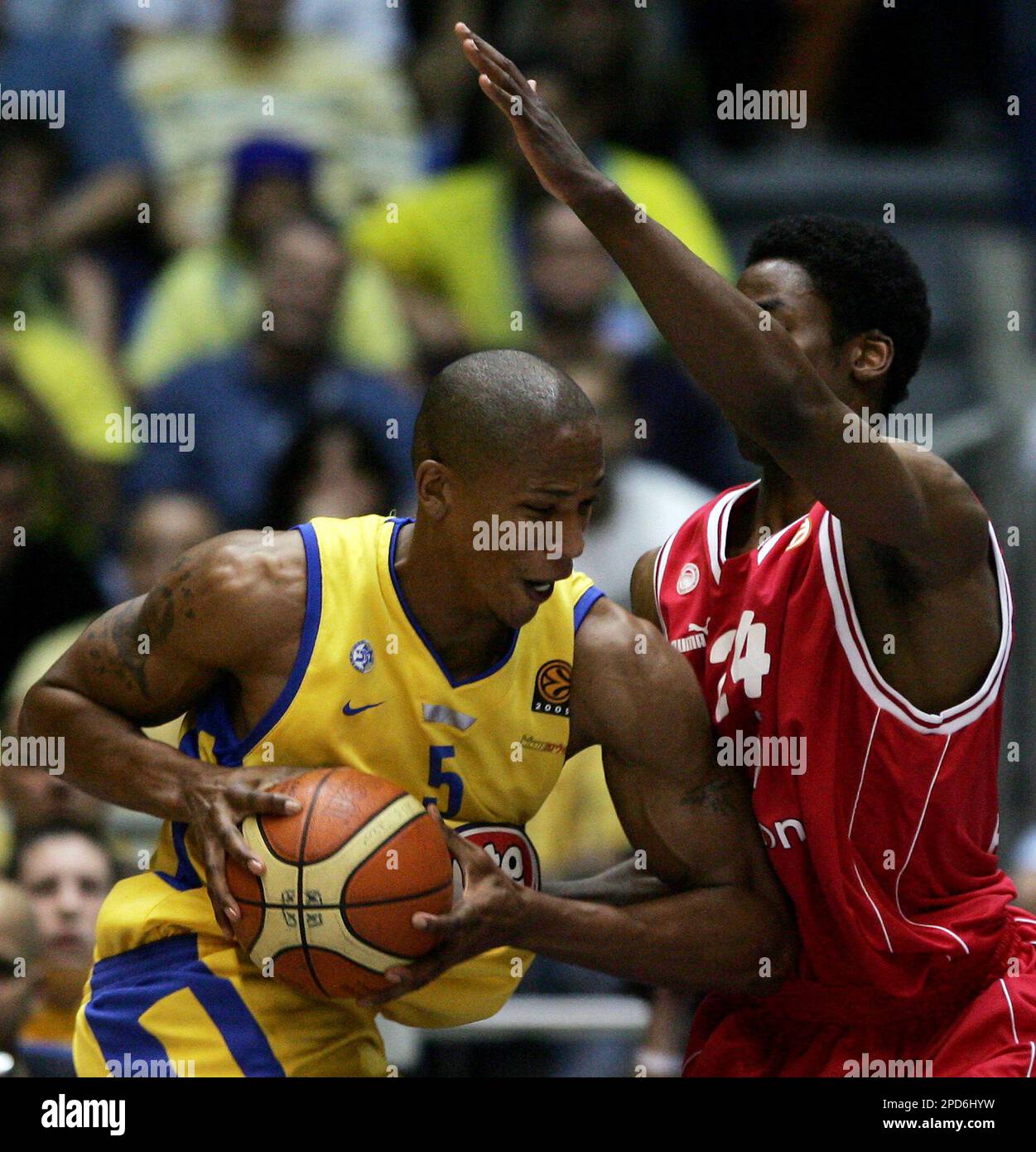 Maccabi Tel Avivs American player Maceo Baston, left, goes to the basket as Olympiacos Quincy Lewis of the USA tries to block him during their Euroleague Quarterfinal Playoff basketball match in Tel