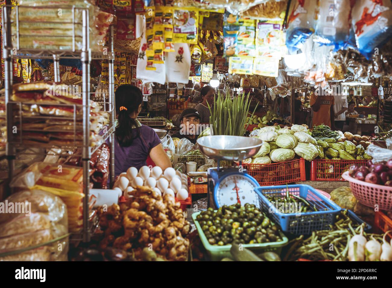 A group of people in a grocery store, admiring the fresh produce and