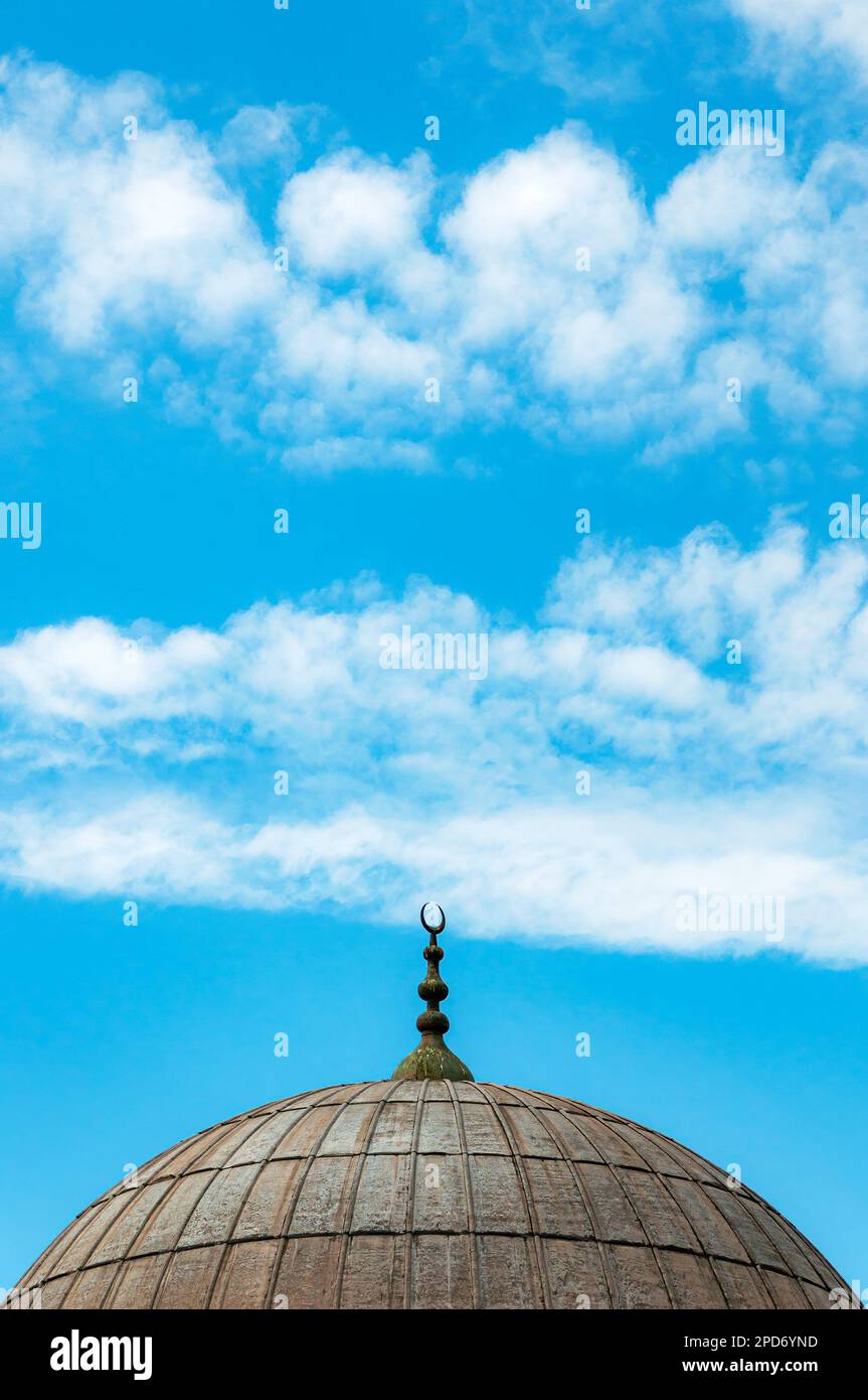 A dome from one of the many Mosques in Istanbul against a blue sky background. Stock Photo