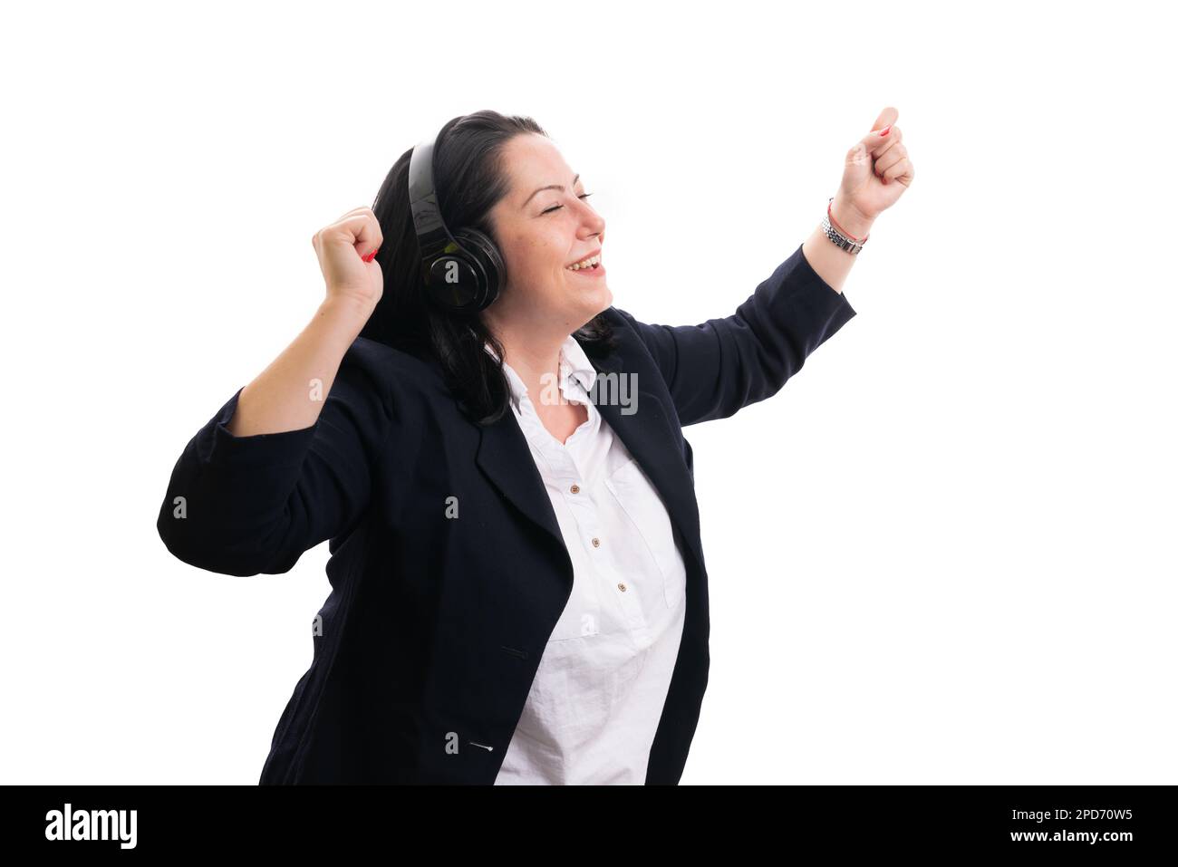 Cheerful adult businesswoman dancing while enjoying music in headphones wearing smart-casual clothing as corporate office concept isolated on white ba Stock Photo