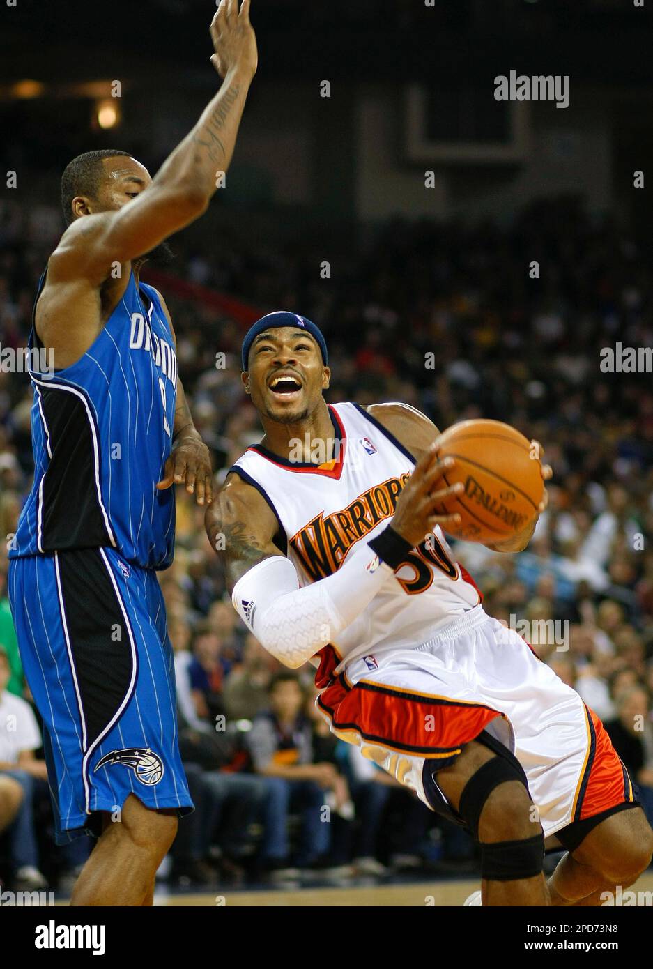 Golden State Warriors' Corey Maggette (50) drives to the basket as