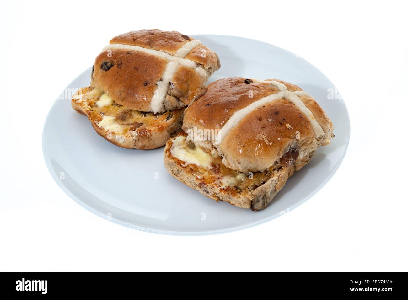 Freshly baked and toasted hot cross buns with butter white background