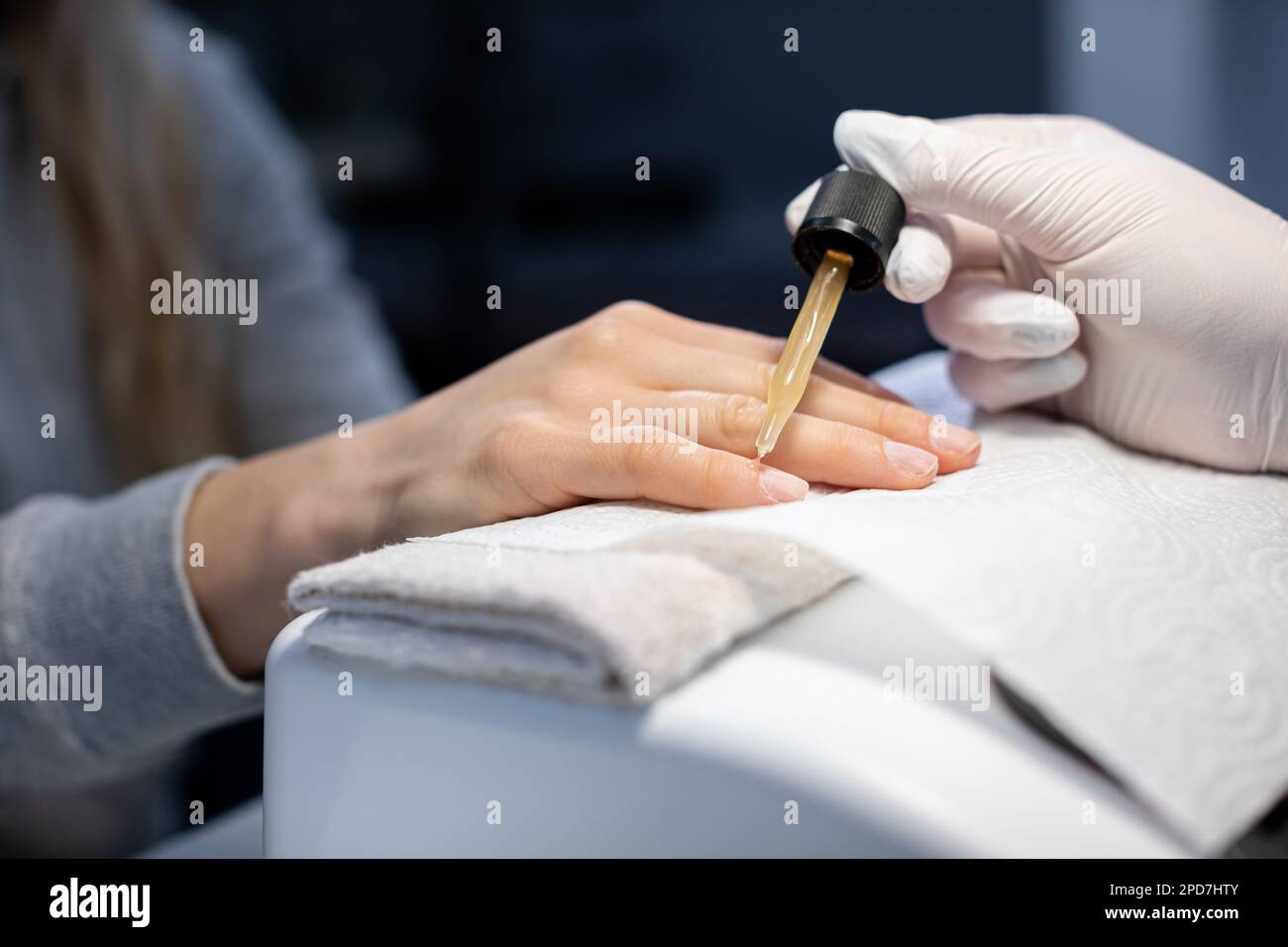 Use of nail care oil in a professional beauty salon Stock Photo Alamy