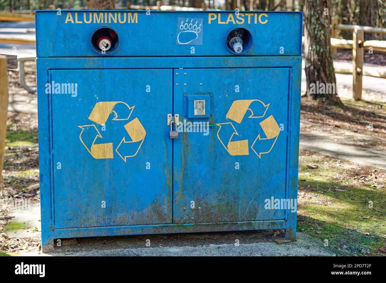 A big blue recycle garbage can showing the recycle logo for aluminum and plastic only and bear proof in a picnic area at a park in the mountains of Te Stock Photo