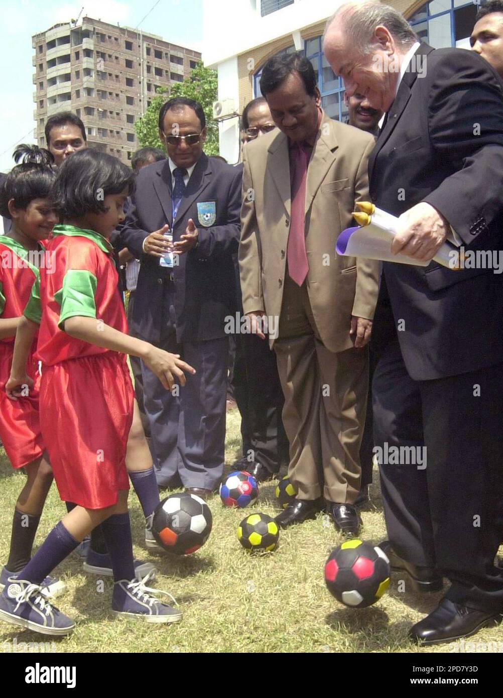 FIFA President Sepp Blatter, right, plays with children with soccer