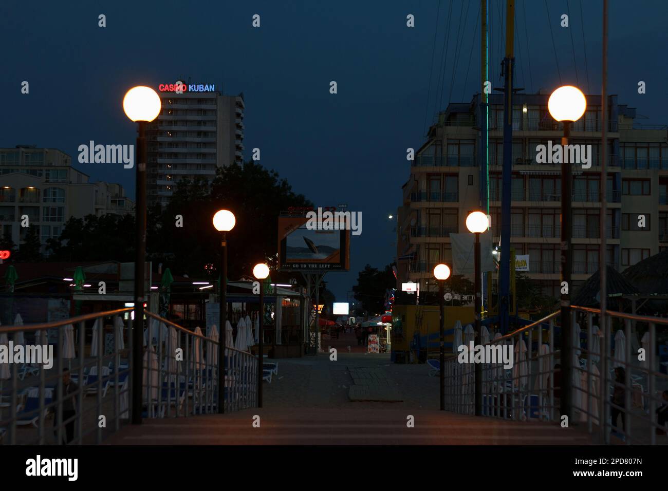 SUNNY BEACH, BULGARIA - JUNE 28, 2015: Resort coastal area, infrastructure with hotels, shops and a beach on the Black Sea in the evening. Lights on t Stock Photo