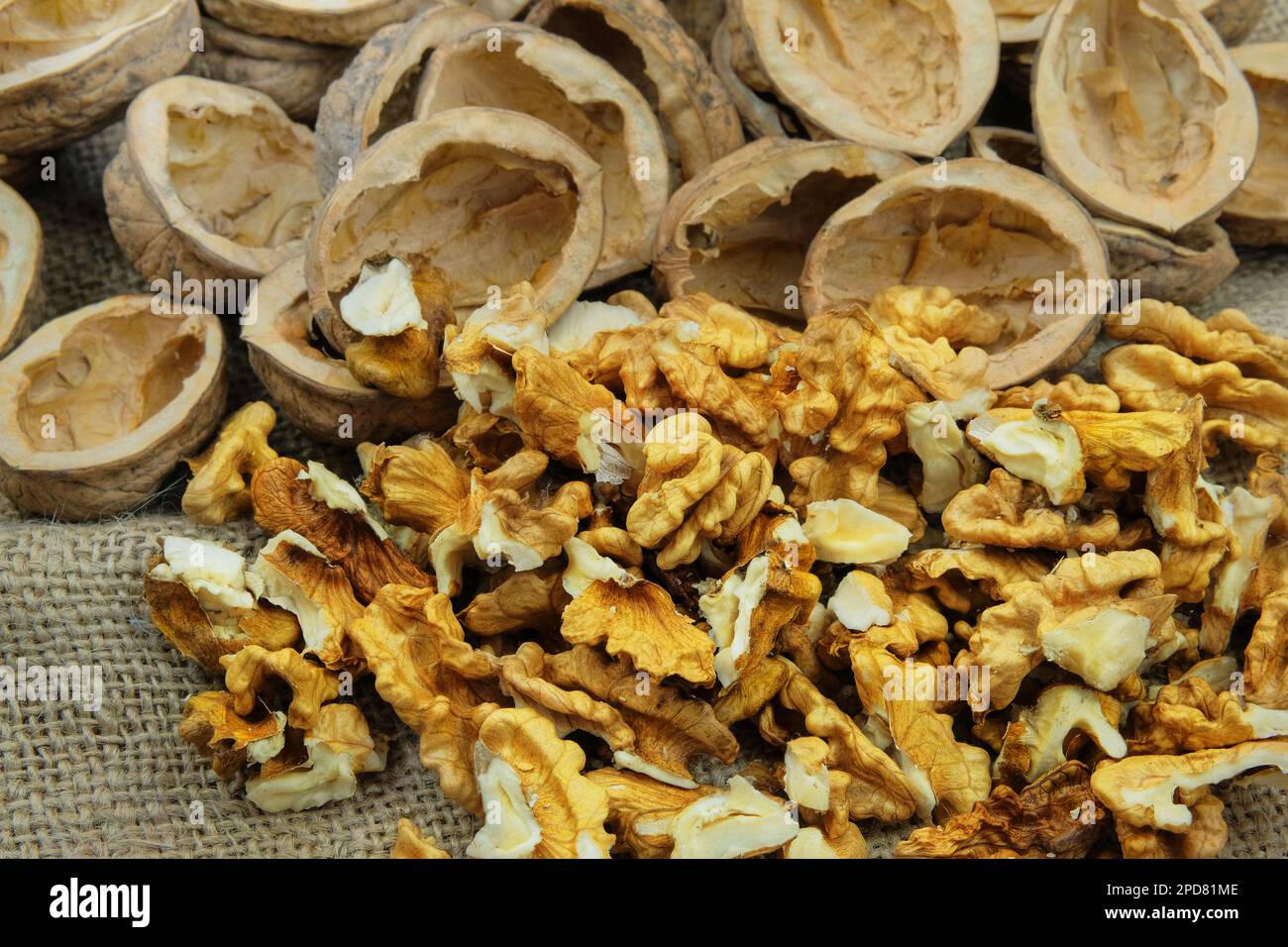 Walnuts on old rustic table. Walnut kernels and walnut shell. Stock Photo