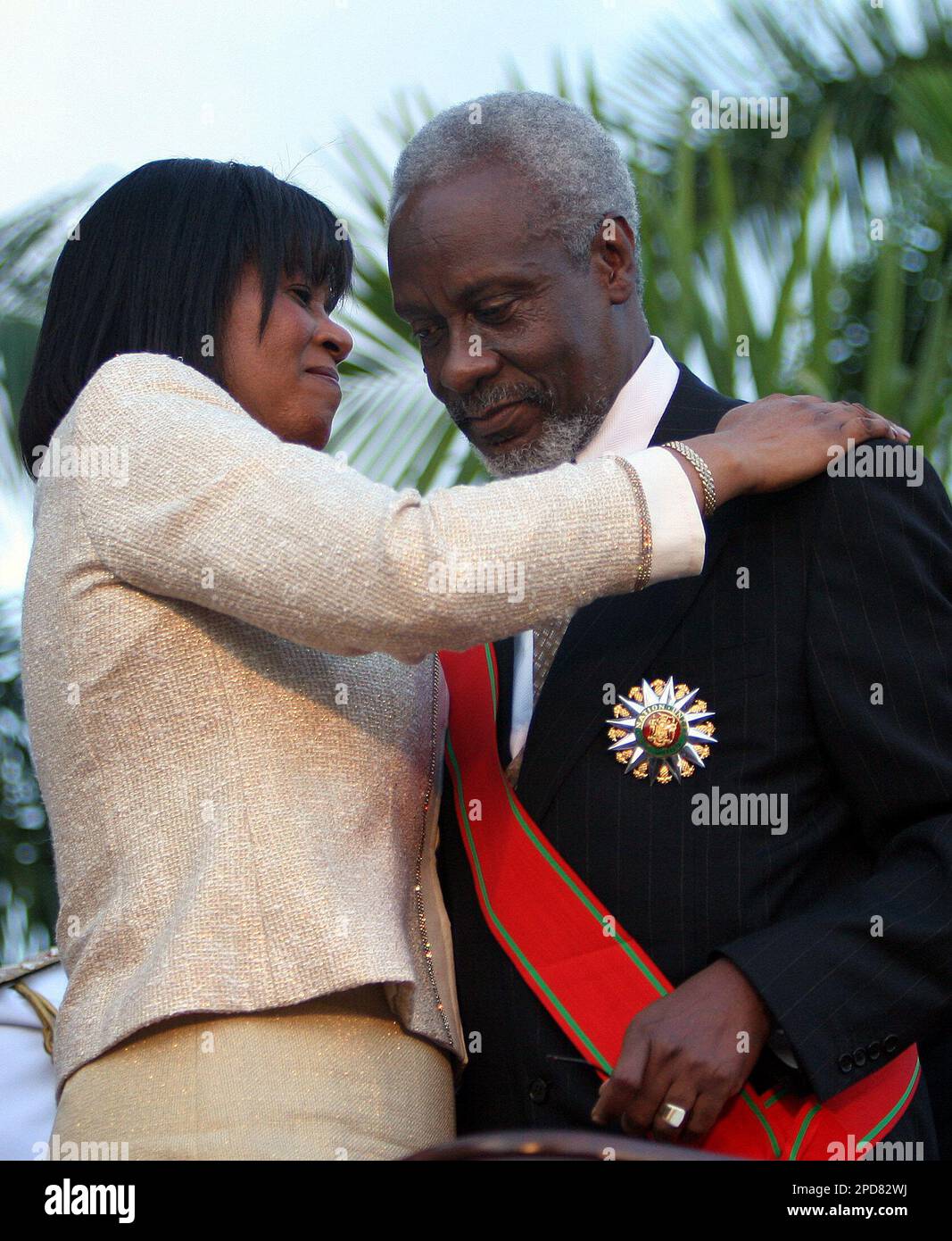 Jamaica's new Prime Minister Portia Simpson Miller, left, embraces ...