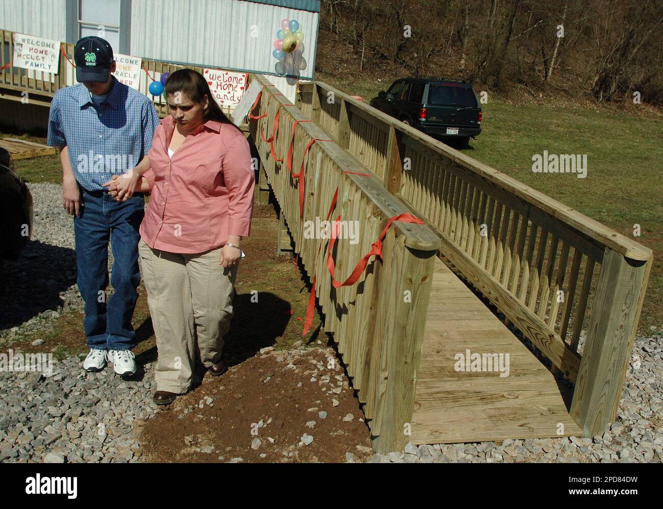 Mine survivor Randal McCloy Jr., left, and his wife Anna walk outside