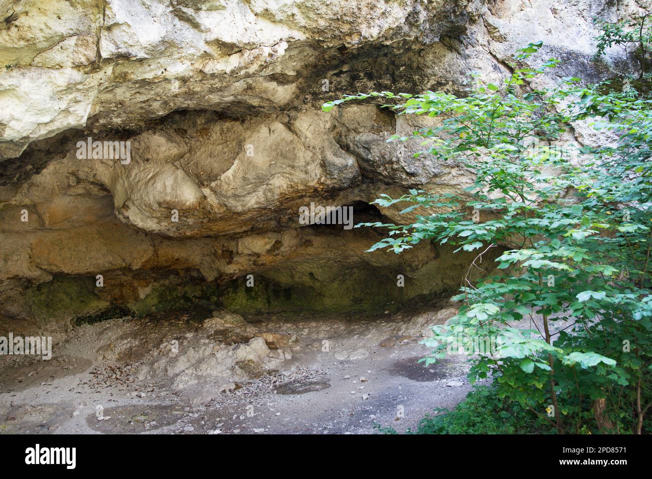 Entrance to a karst monolithic cave of natural origin. The cave was