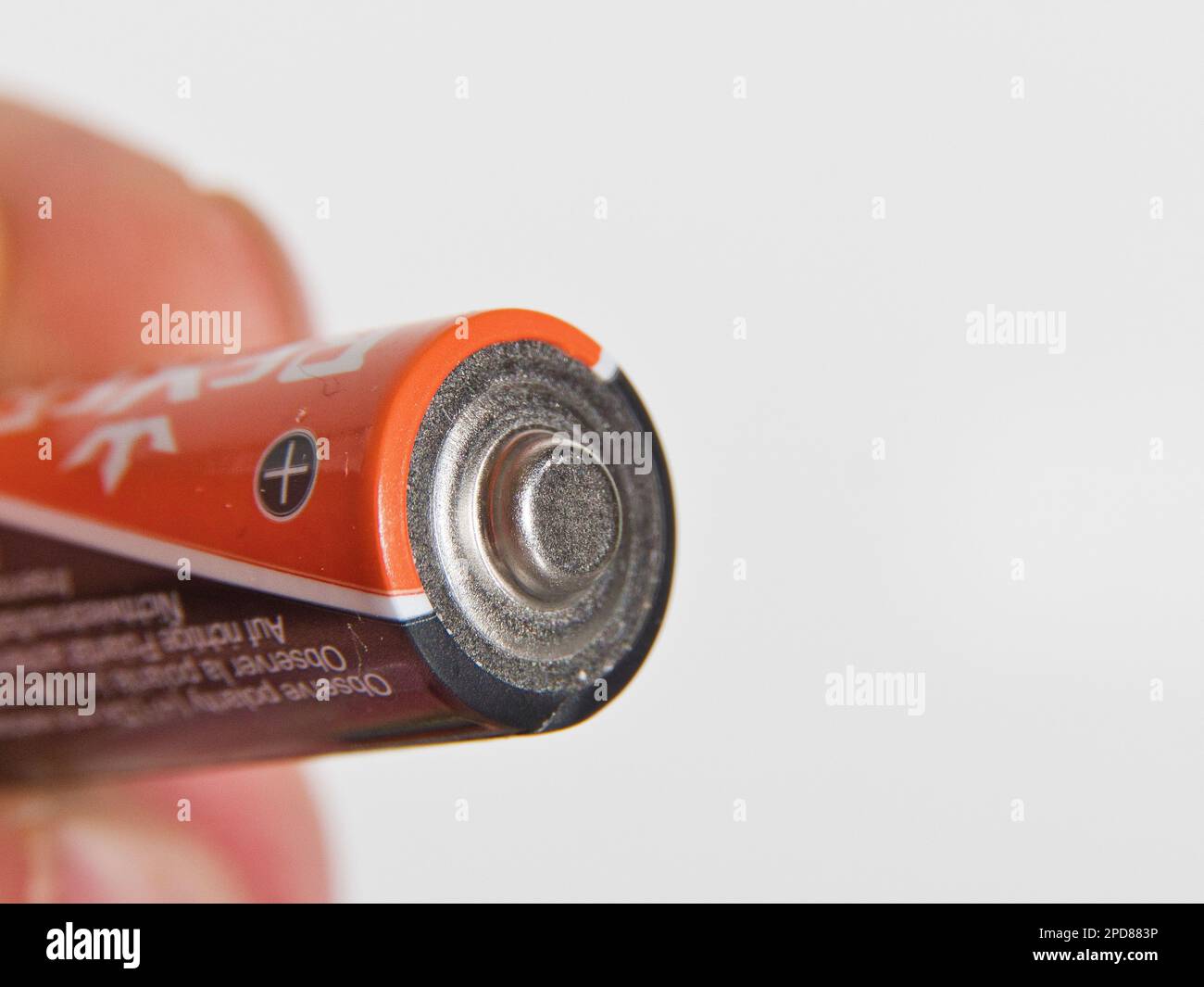Hand holding AA batterie, isolated on white background Stock Photo Alamy