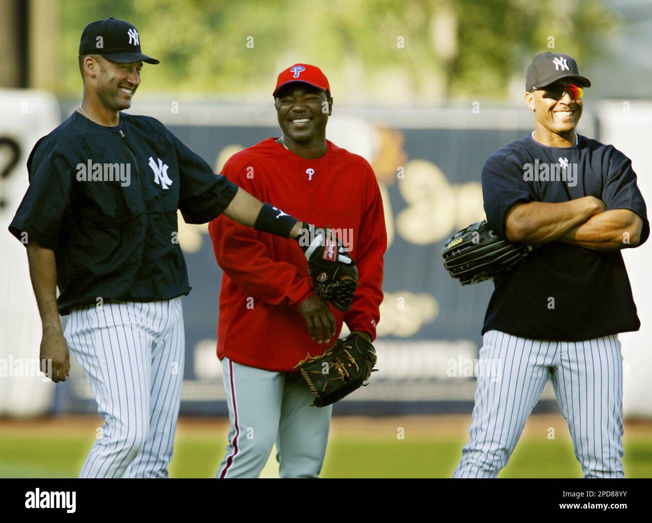 New York Yankees shortstop Derek Jeter, left, teases Philadelphia Phillies relief pitcher Tom