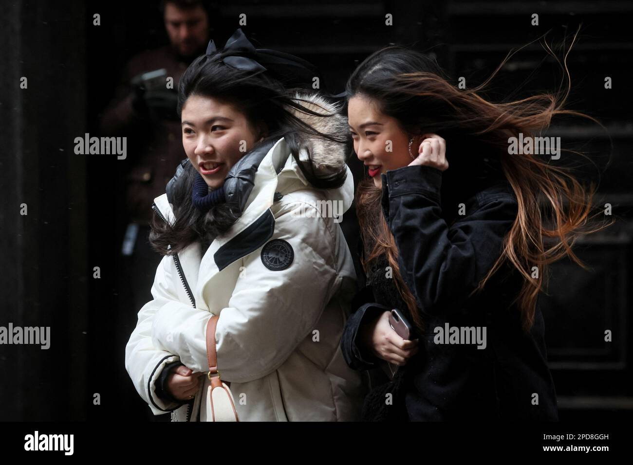 People make their way through snow and wind during a Nor'easter storm