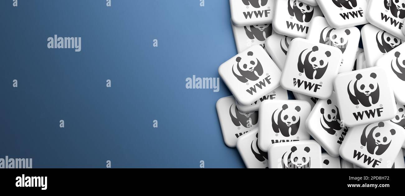 Logos of the NGO  World Wide Fund for Nature WWF on a heap on a table. Copy space. Web banner format. Stock Photo
