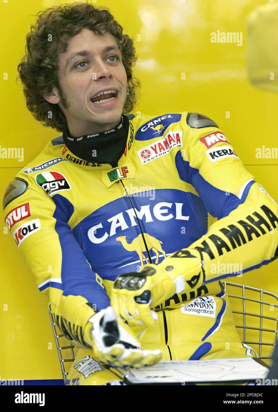 Valentino Rossi of Italy puts on his gloves during the first day's