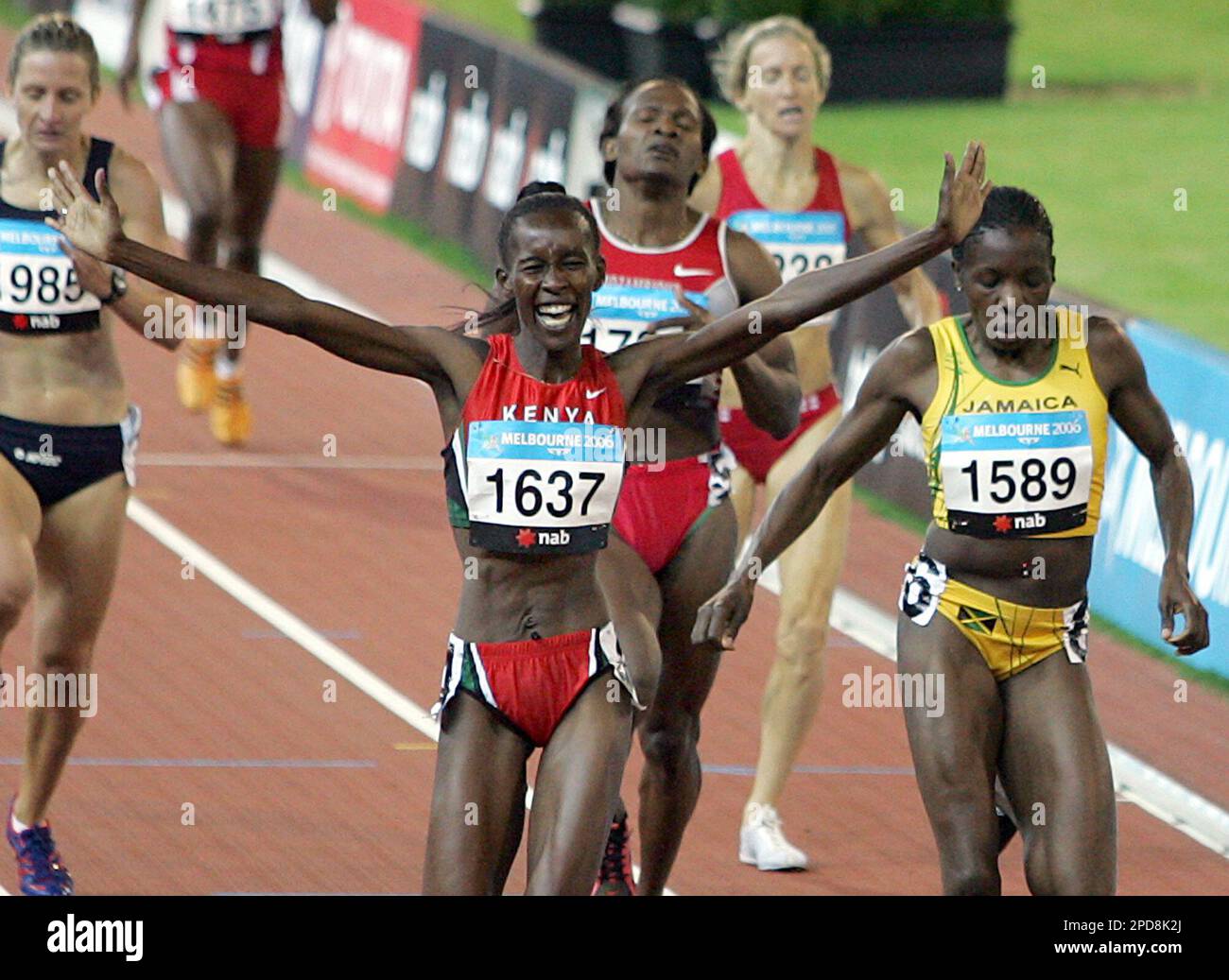 Kenya's Jepkosgei, left, celebrates as she crosses the finish
