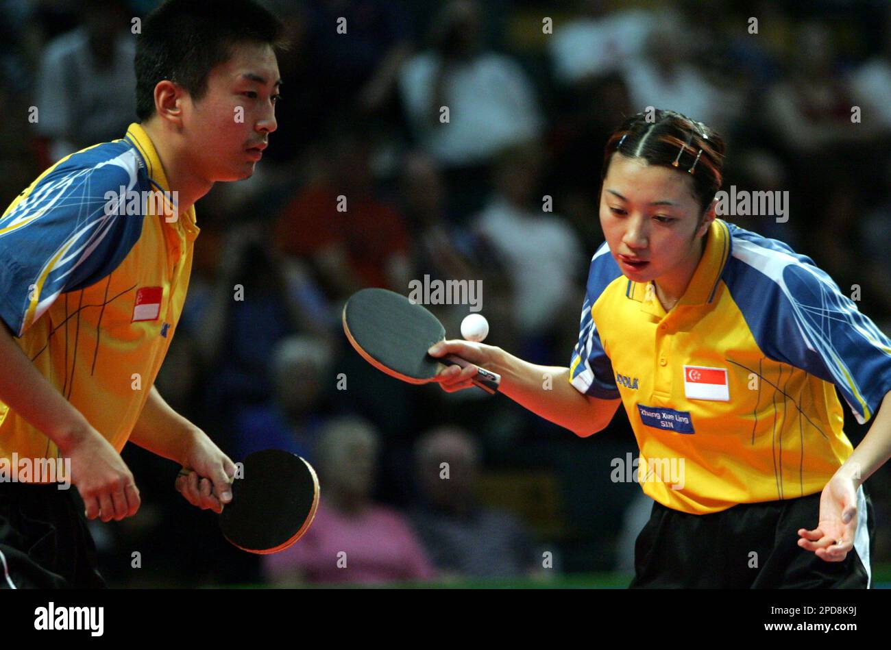 Singapores Zhang Xue Ling serves as Yang Zi, left, looks on in the gold medal match of the Commonwealth Games table tennis mixed doubles competition in Melbourne, Australia, Friday, March 24, 2006.