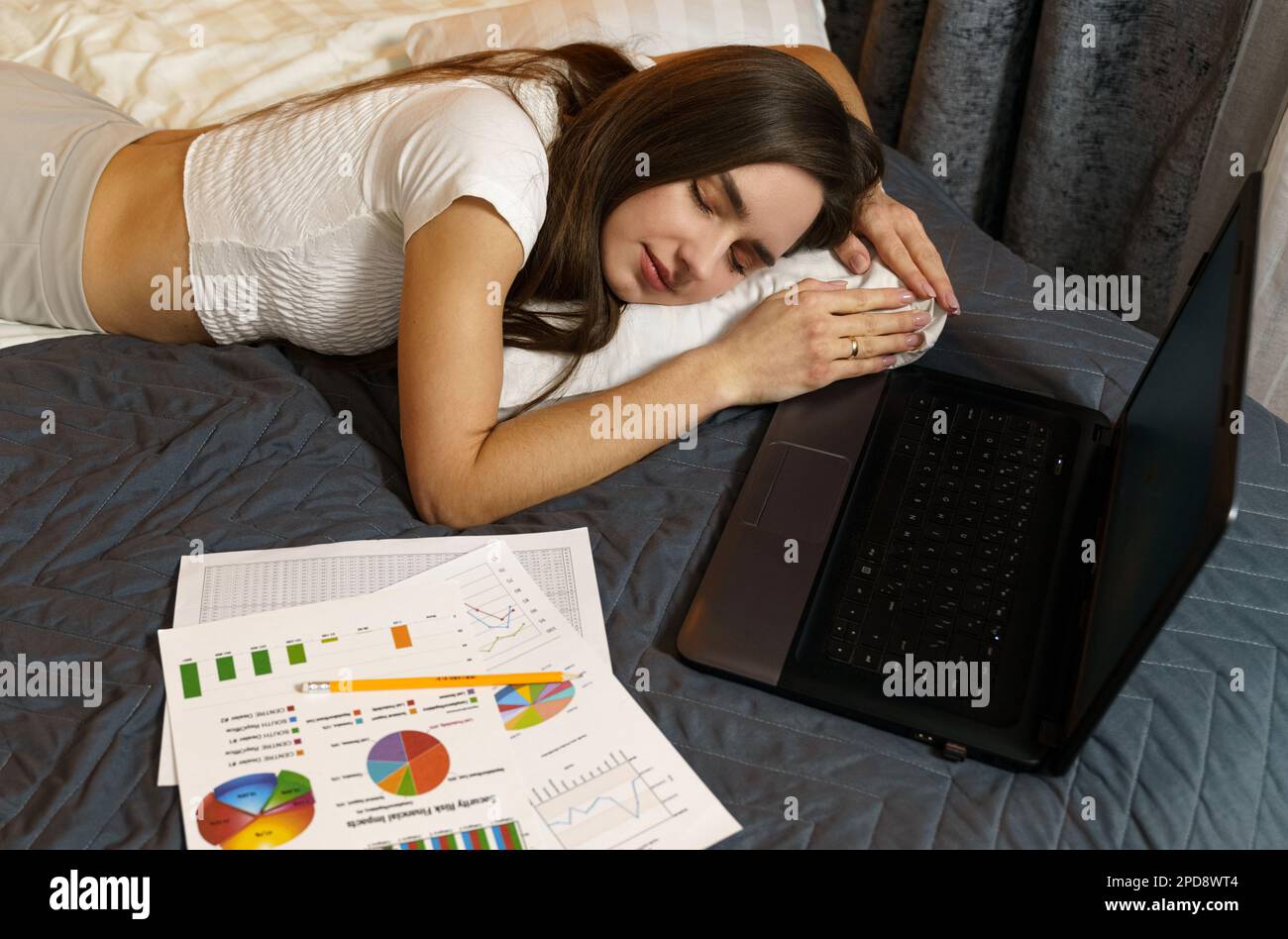 A young girl fell asleep in bed studying reporting information work