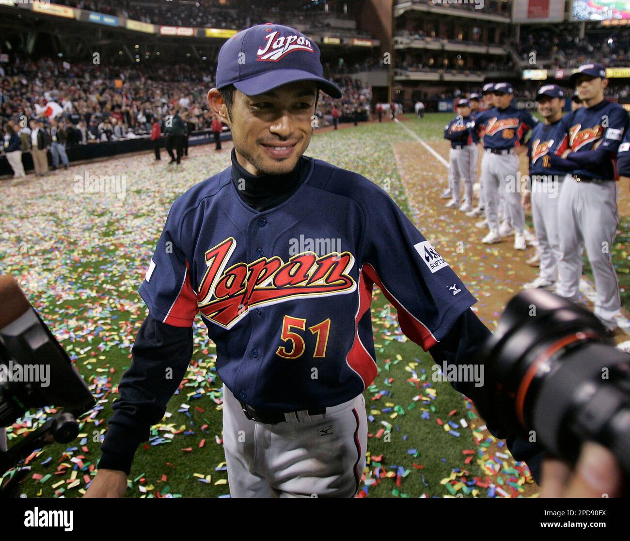 Team Japan's Ichiro Suzuki (51) celebrates with teammates after