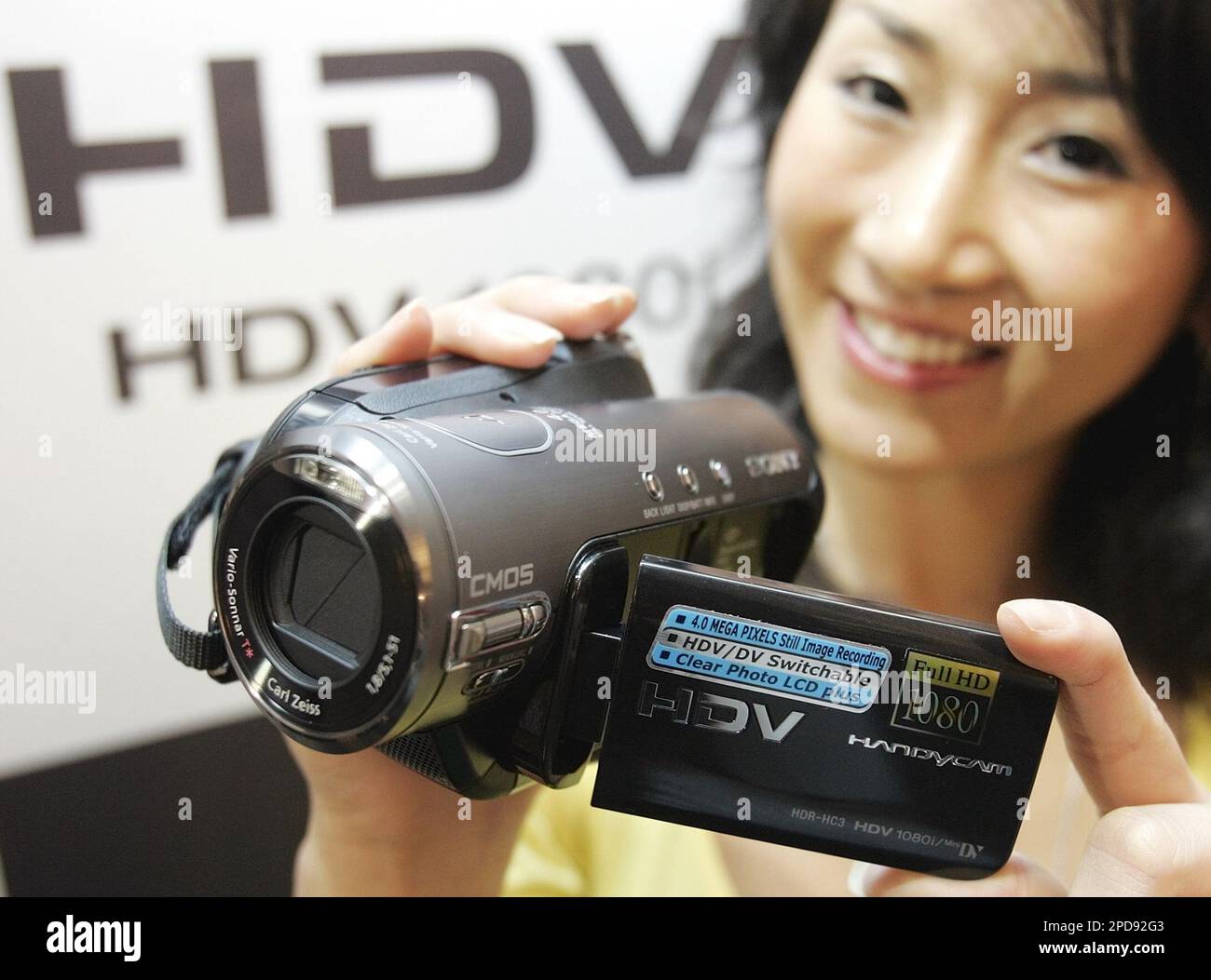 A model displays Sony Korea Corp.'s new Handycam HDR-HC3 in Seoul Monday,  March 20, 2006. The prices of the new digital high-definition camcorder  camera with CMOS sensor, will put it on the
