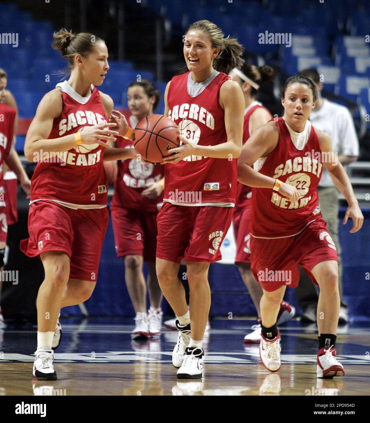 Sacred Heart's Nicole Rubino, left, Amanda Pape, center, and Kerri Burke, right, run through a drill during a practice session on Saturday, March 18, 2006, in State College, Pa., the day before the First Round play of the 2006 NCAA Division I Women's Basketball Championship. (AP Photo/Carolyn Kaster) Stock Photo