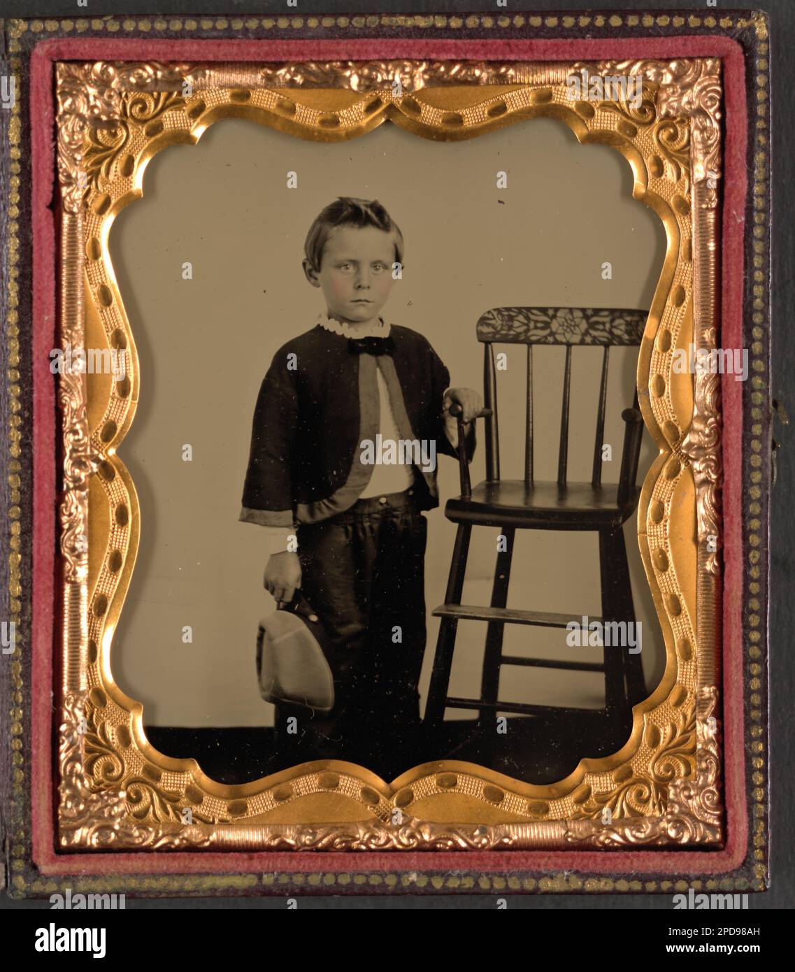 Ambrotype photo of child in chair holding apple c. 1860s Ambrotype photo of child in chair holding apple c. 1860s