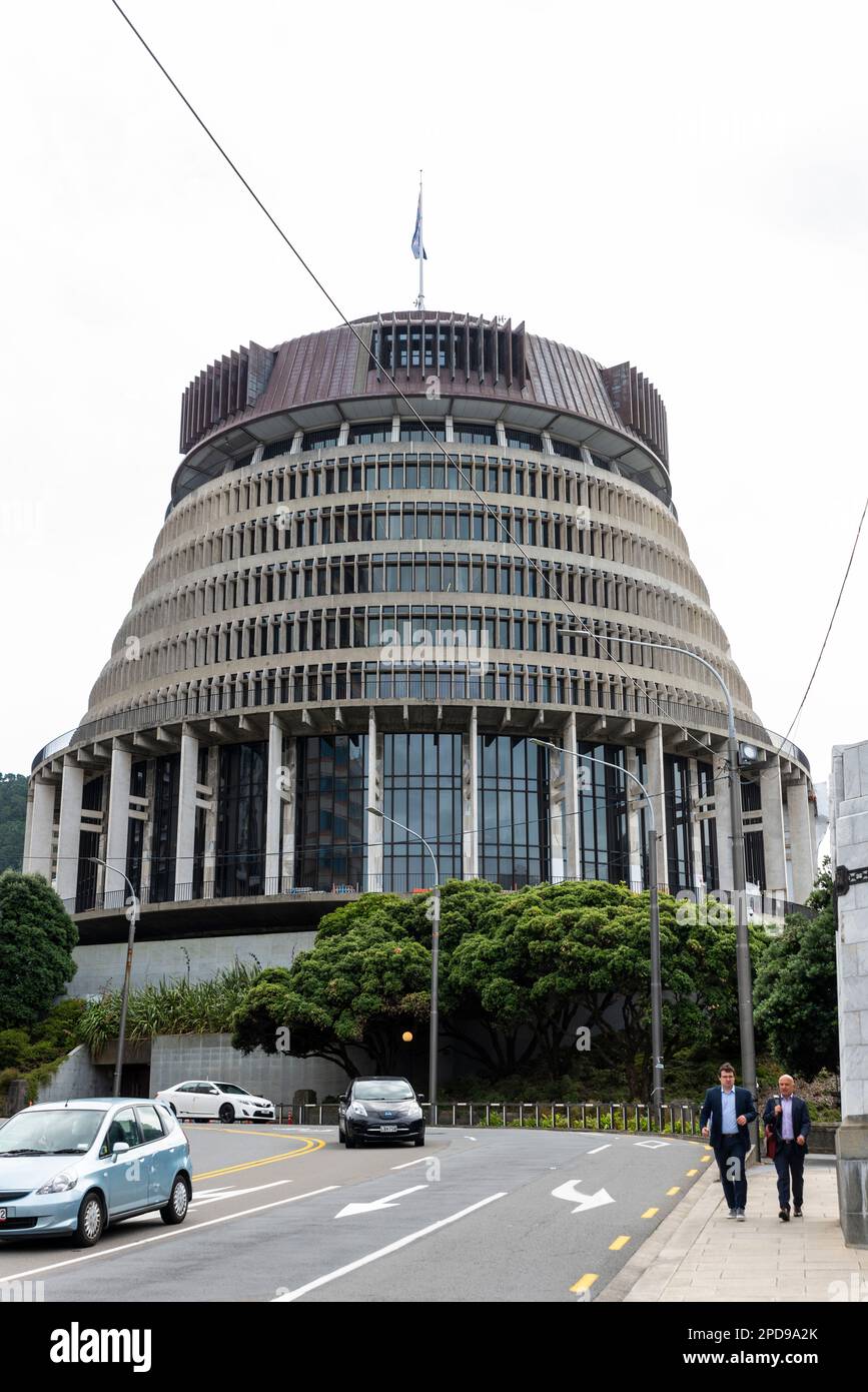 The Beehive, Executive Wing of New Zealand Parliament Buildings in Wellington, New Zealand. Businessmen in suits walking in Bowen Street Stock Photo